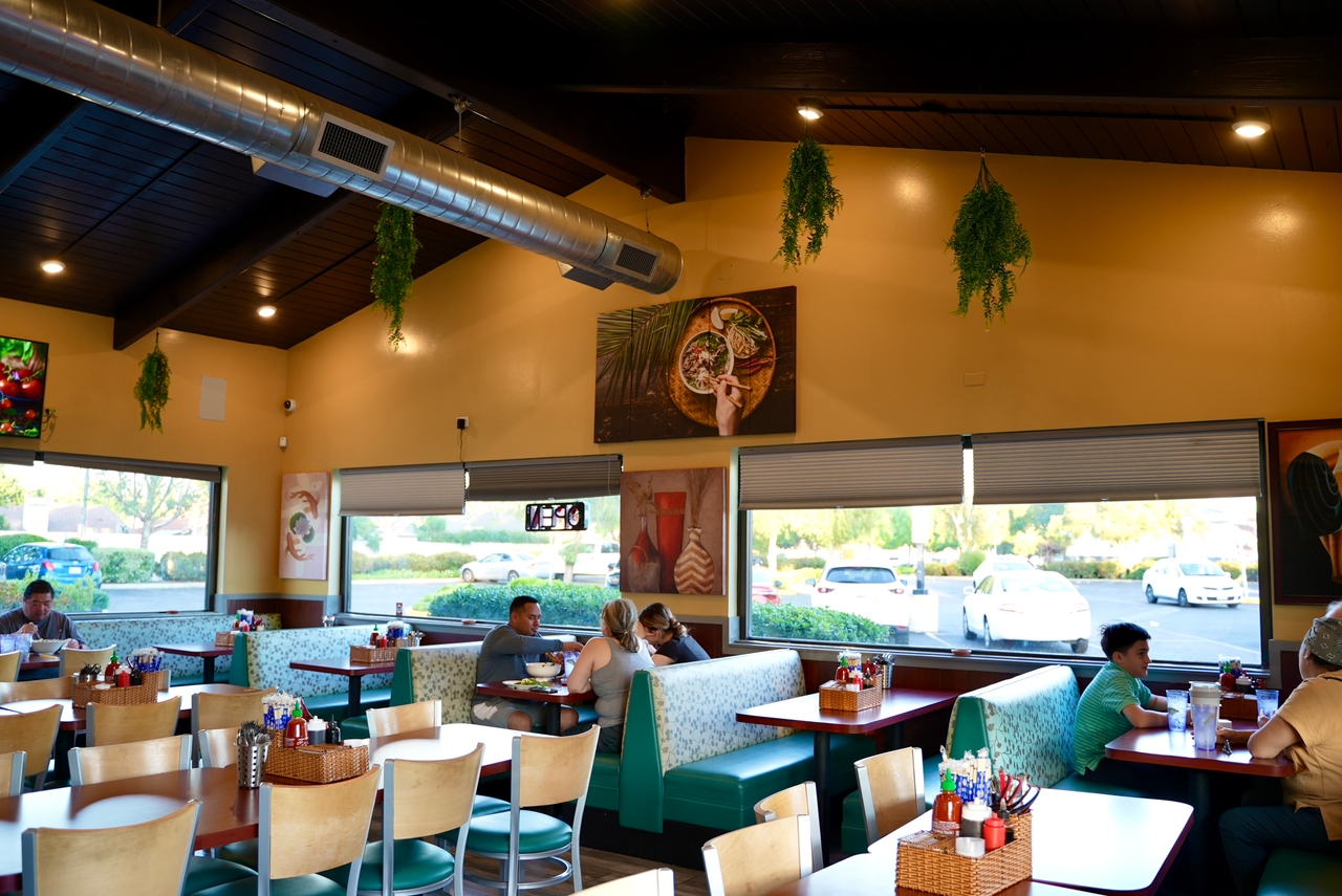 Cozy interior of iPho restaurant with traditional Vietnamese decor and dining tables